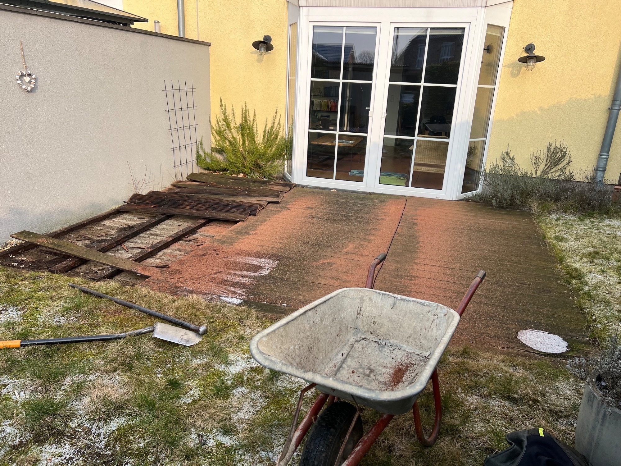 Alte Terrasse vor der Sanierung mit Schubkarre und Baustelle